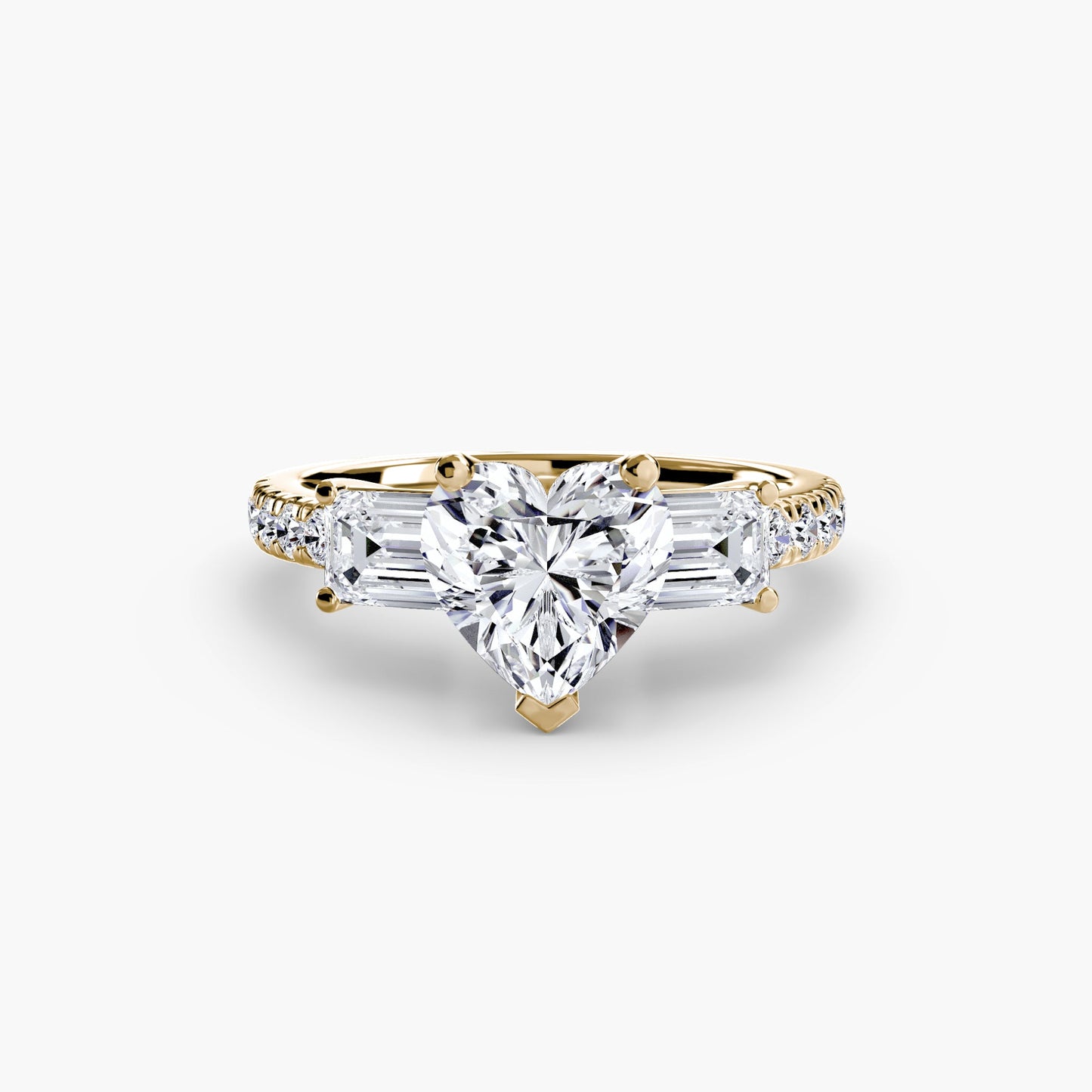 Gold ring with a heart-shaped diamond on a white background